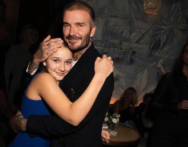 Beckham, embracing their daughter Harper